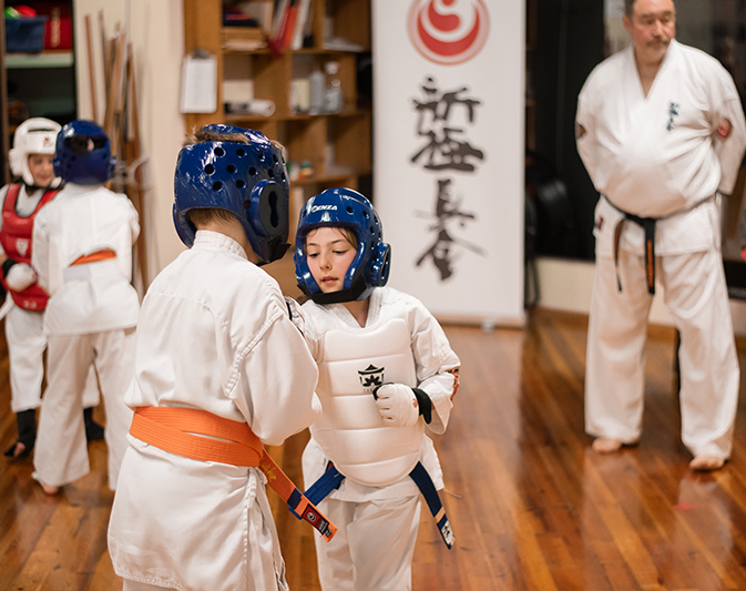 Karate student demonstrating strength and focus during the exam